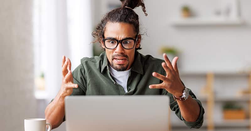 person looking confused at their laptop as they fall into email marketing pitfalls