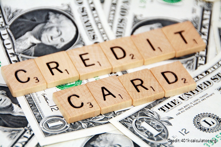 Word tiles spelling "Credit Card" laid out on top of money