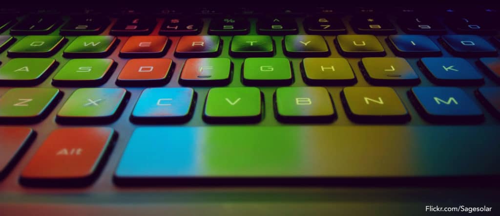 Illuminated keyboard showing a rainbow of reflected screen colors