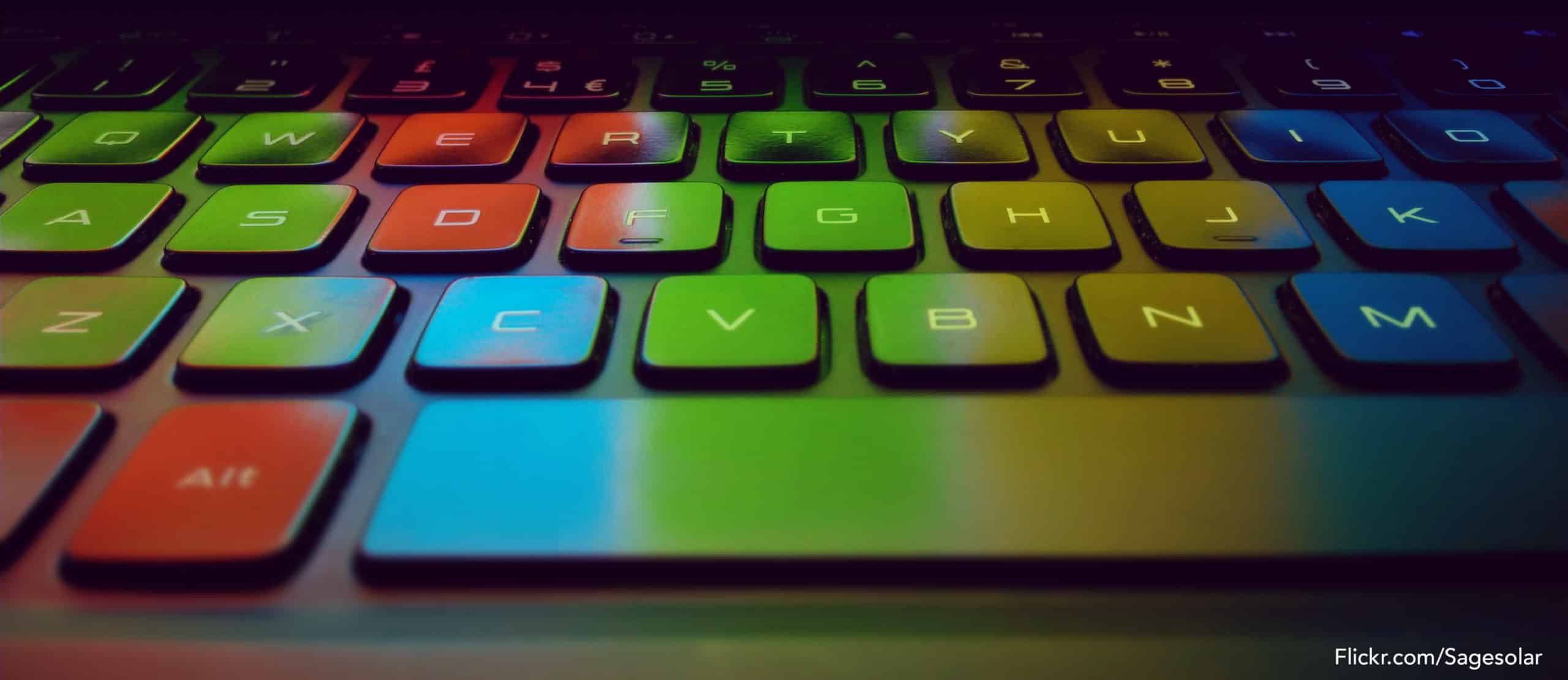 Illuminated keyboard showing a rainbow of reflected screen colors