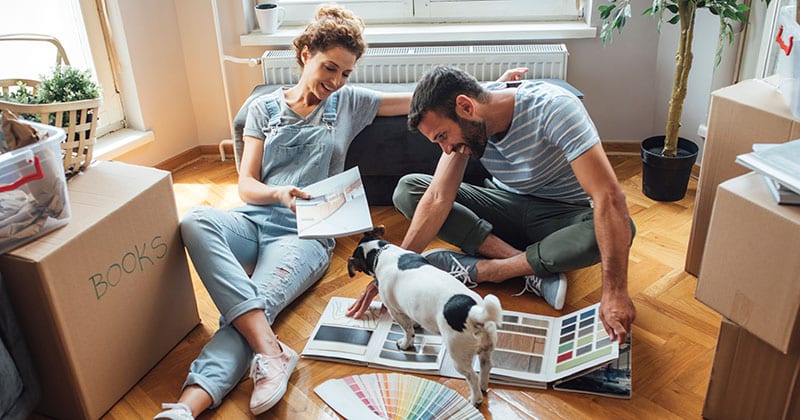 Husband and wife and their dog moving in new home.