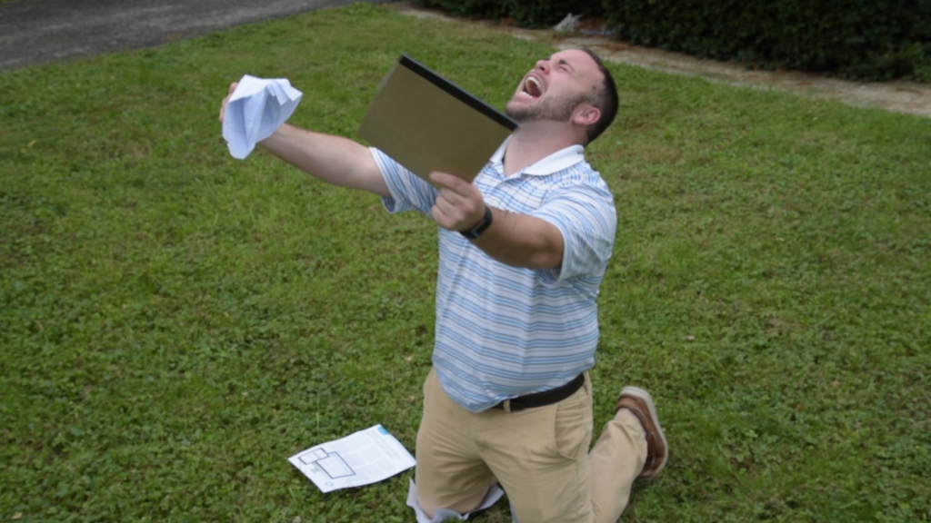 Angry Sales Rep on knees in grass with hands out