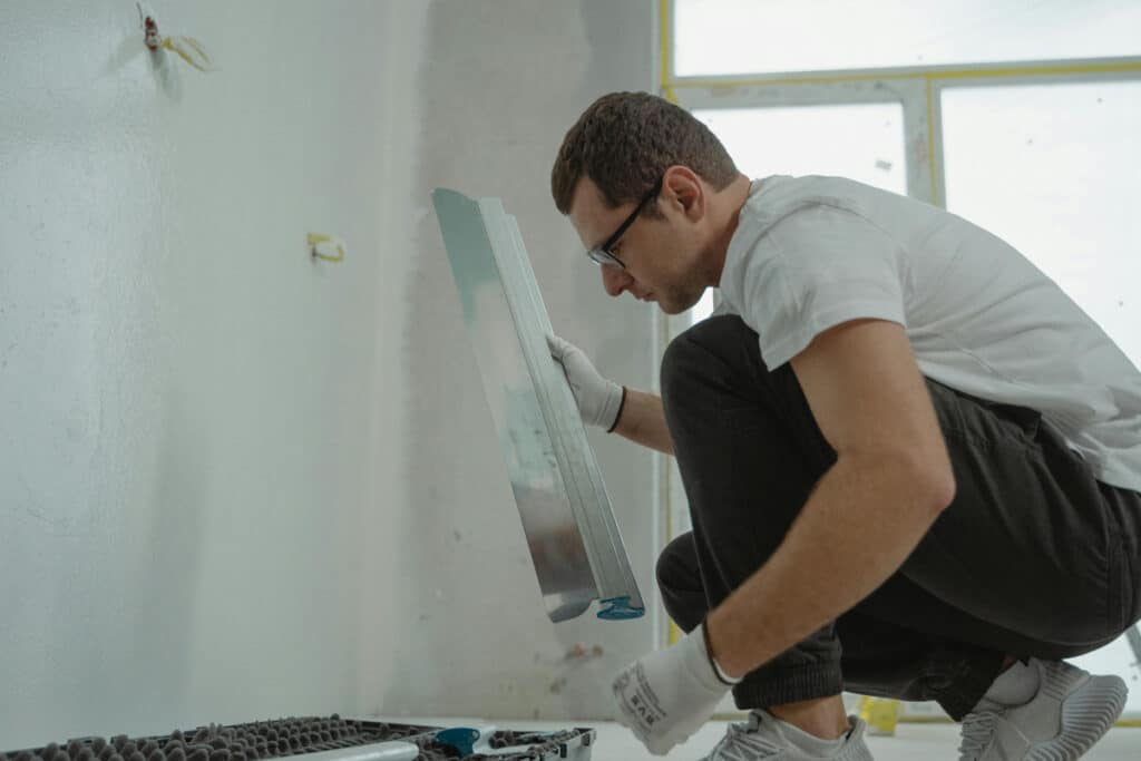 Contractor checking materials on site after calculating markup and margin for the job.