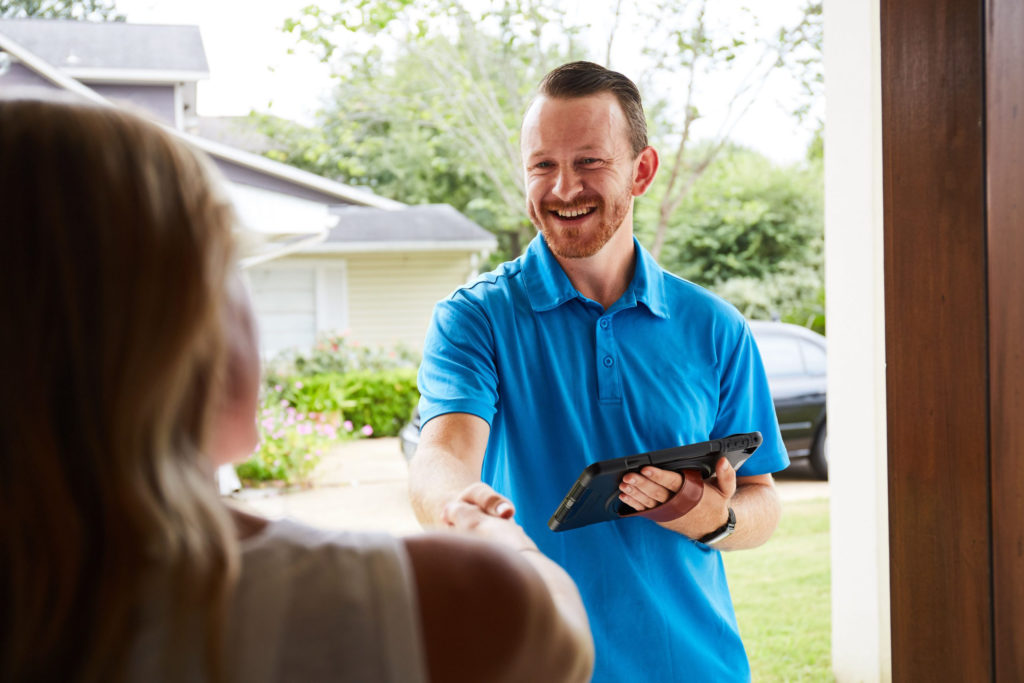 sales rep at front door with tablet